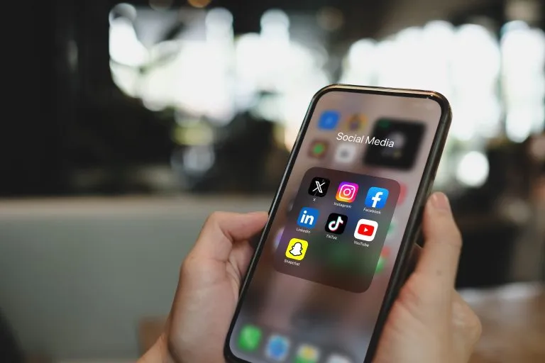 a smartphone showing a brand's social feed with high engagement
