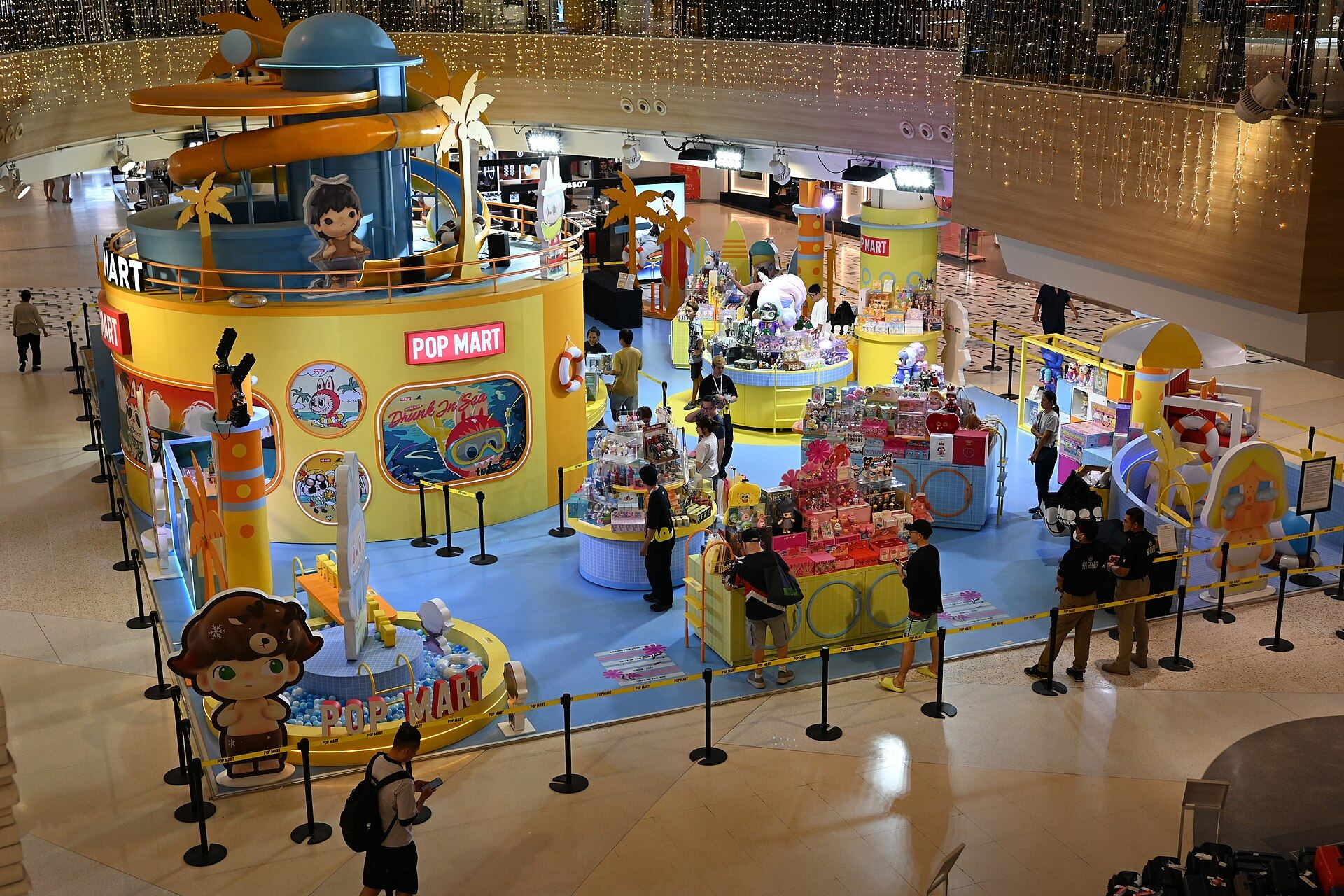 A brightly coloured Pop Mart pop-up filling a shopping-mall atrium