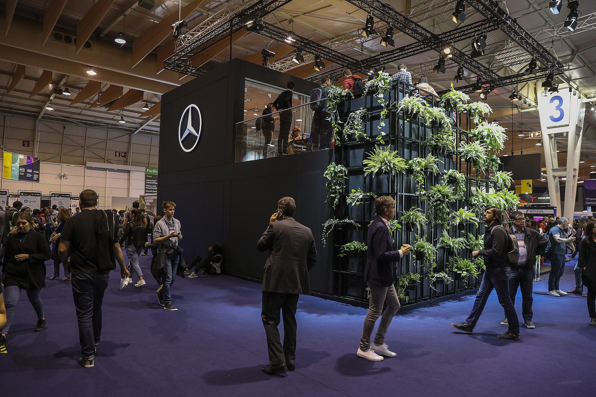 Mercedes-Benz's stand at Web Summit, a black two-storey cube faced with a living plant wall
