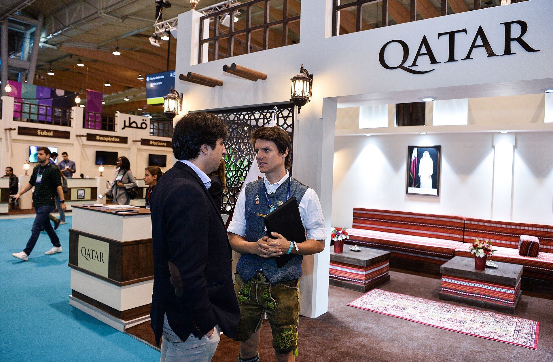 The Qatar pavilion at Web Summit, with carved wooden screens, majlis seating and lanterns