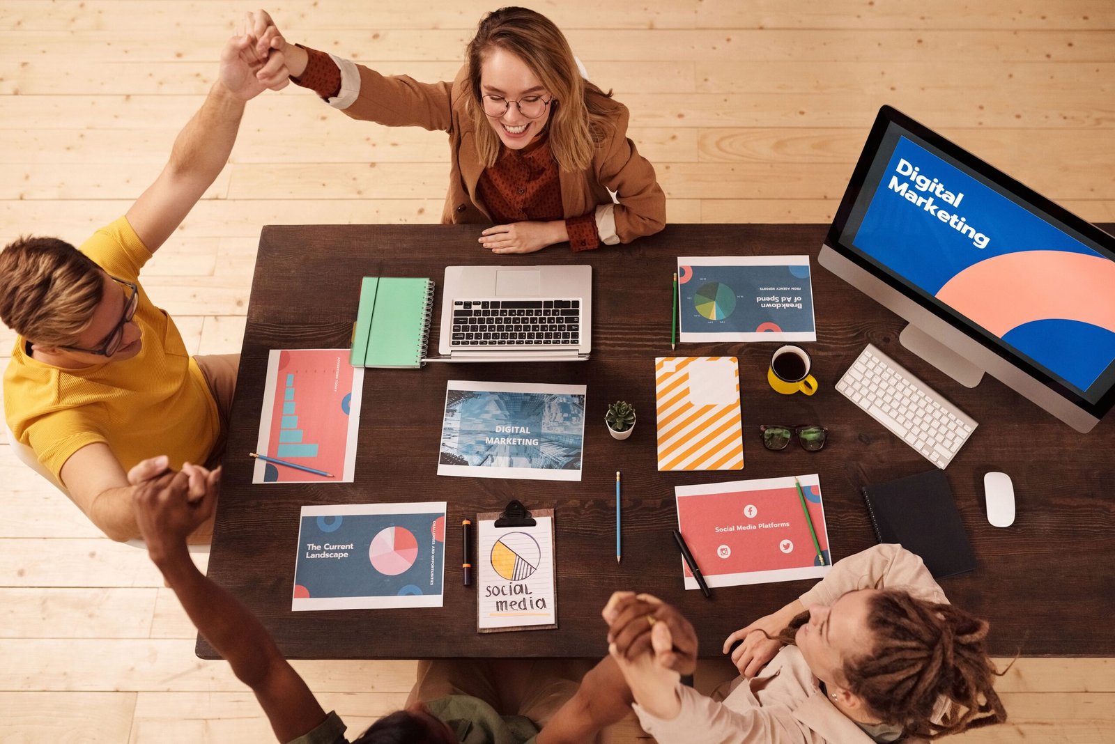 Marketing team reviewing social media analytics on a laptop in an office